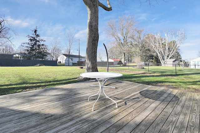 wooden terrace featuring a lawn