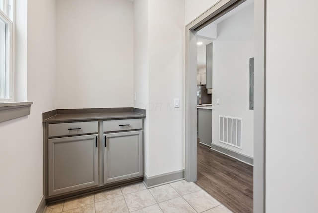 hall with light tile patterned floors