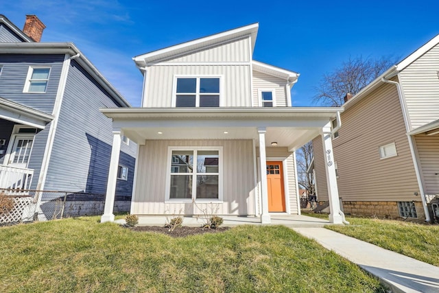 view of front of property featuring board and batten siding, a front yard, a porch, and fence