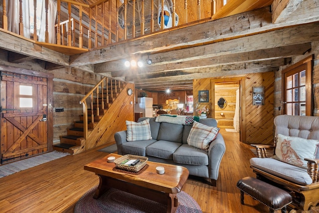 living room featuring hardwood / wood-style flooring and wooden walls