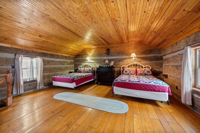 bedroom featuring hardwood / wood-style flooring, wooden ceiling, lofted ceiling, and wood walls