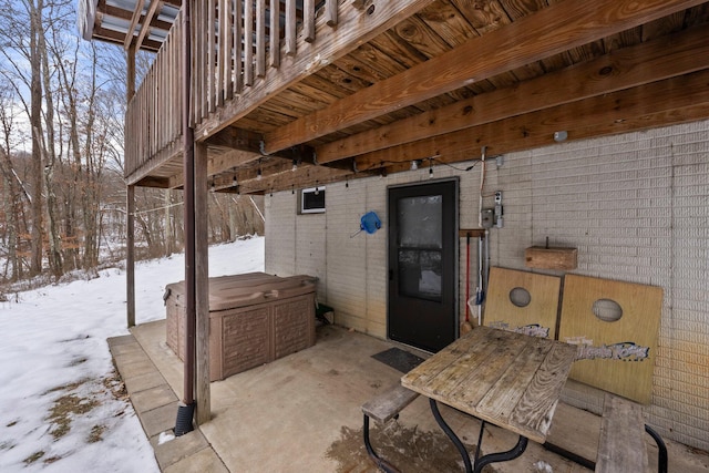 snow covered patio with a jacuzzi