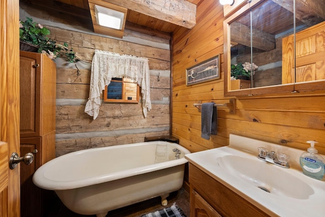 bathroom featuring vanity, a bathtub, and wooden walls