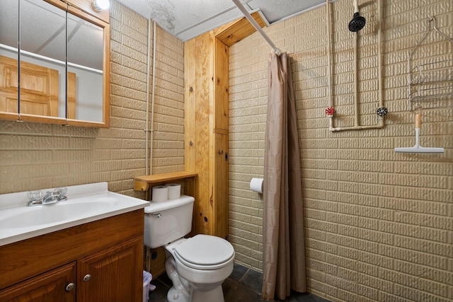 bathroom with toilet, brick wall, and vanity