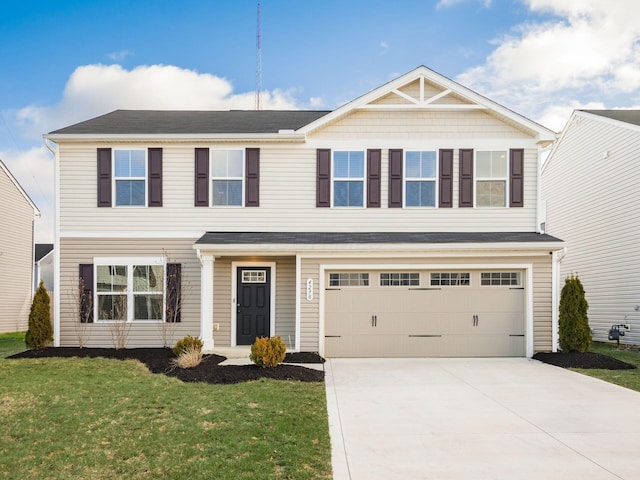 view of front of property featuring a garage and a front lawn