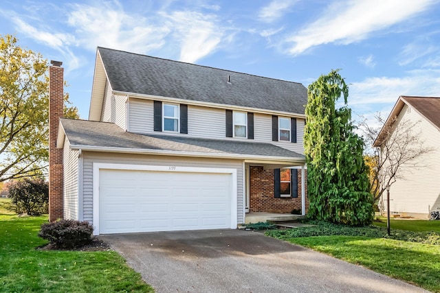 view of front property with a garage and a front yard