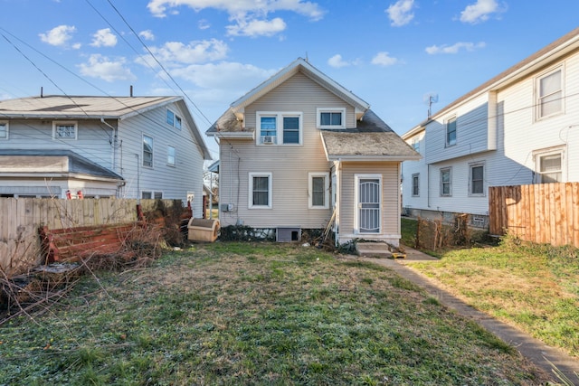 rear view of property featuring a yard