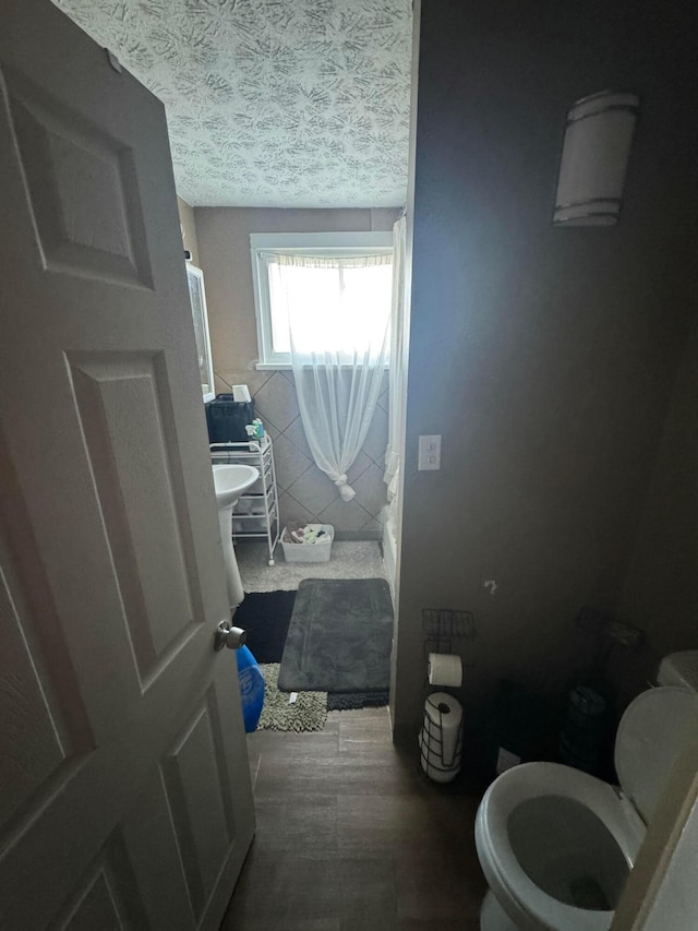 bathroom featuring a textured ceiling and toilet