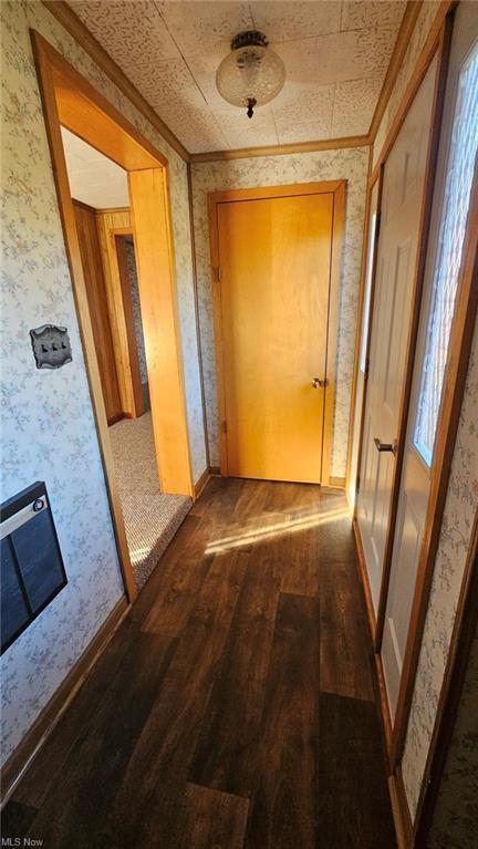 hall featuring wood-type flooring and crown molding