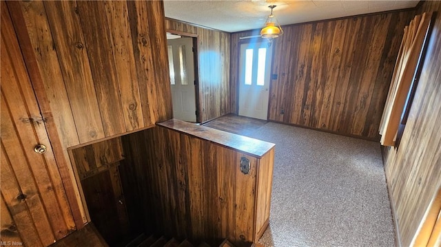 unfurnished room featuring wood walls