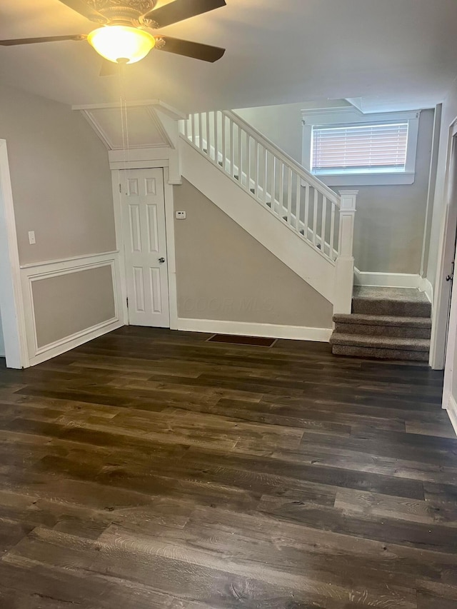 stairs with lofted ceiling, ceiling fan, and wood-type flooring