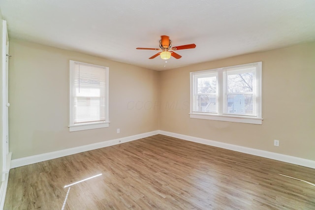 unfurnished room with ceiling fan and hardwood / wood-style floors