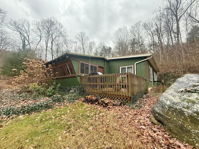 rear view of house with a wooden deck