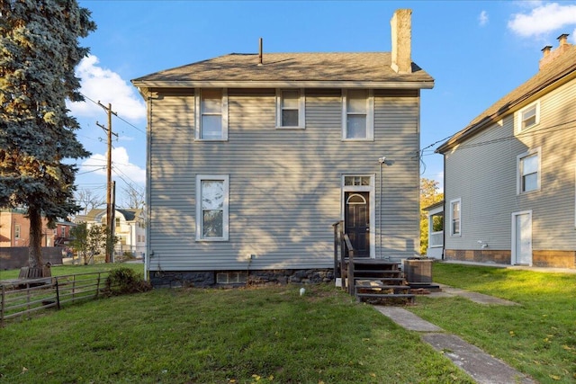 exterior space with a lawn and central AC