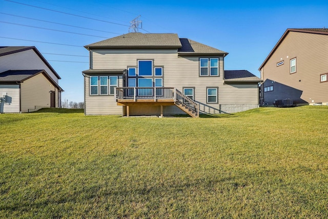 back of house featuring a yard and a wooden deck