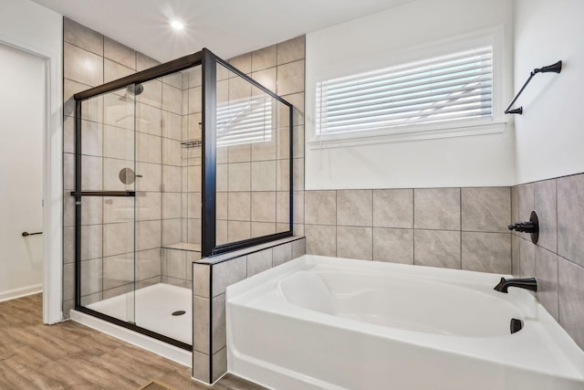 bathroom featuring hardwood / wood-style flooring and separate shower and tub