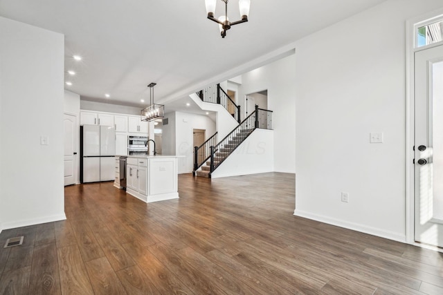 unfurnished living room with dark hardwood / wood-style floors