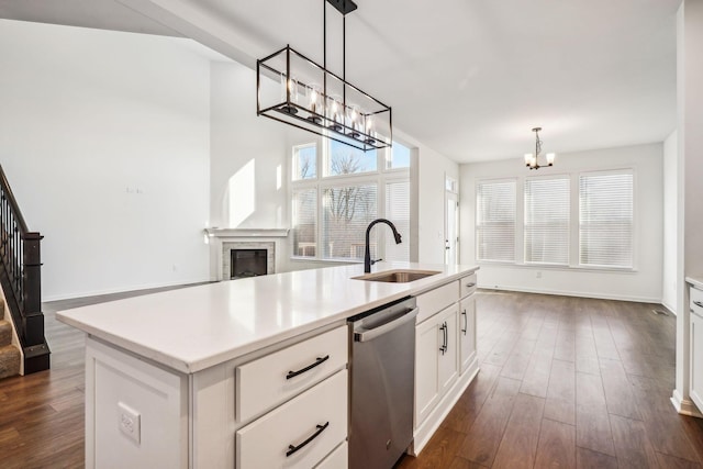 kitchen with dishwasher, sink, an island with sink, decorative light fixtures, and white cabinetry