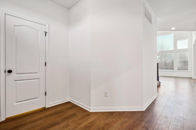 hallway with dark hardwood / wood-style flooring