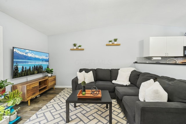 living room with lofted ceiling and dark hardwood / wood-style floors