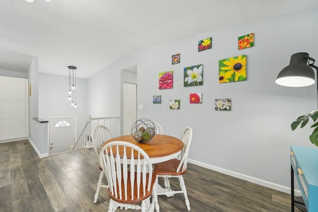 dining room featuring lofted ceiling and dark hardwood / wood-style flooring