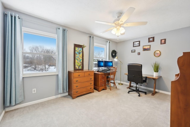 carpeted office space featuring ceiling fan