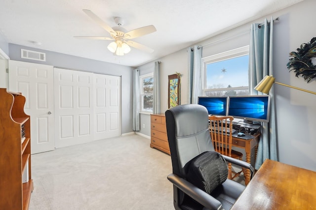 office space with ceiling fan and light carpet