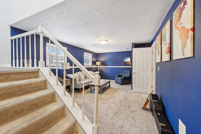 interior space with a textured ceiling and carpet