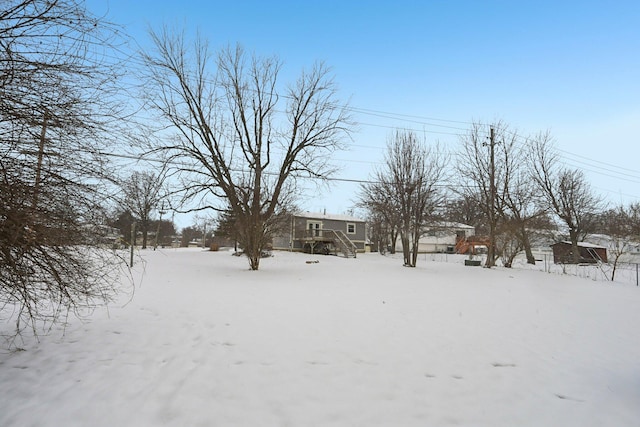 view of yard layered in snow