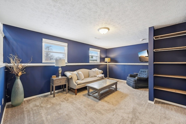 carpeted living room featuring a textured ceiling