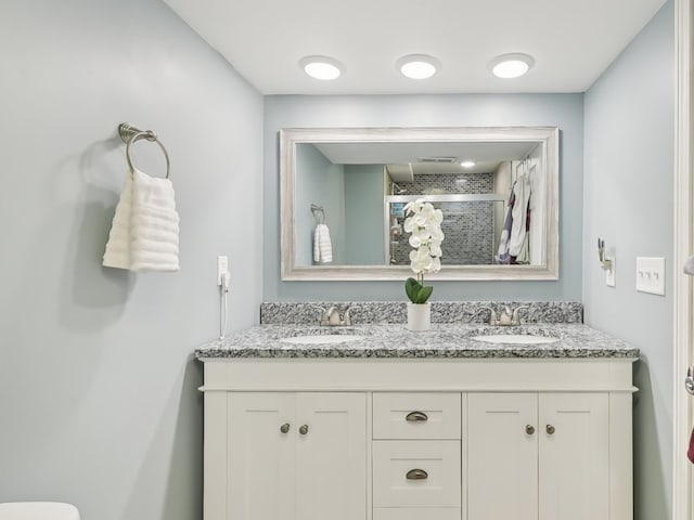 bathroom featuring vanity and a shower with shower door