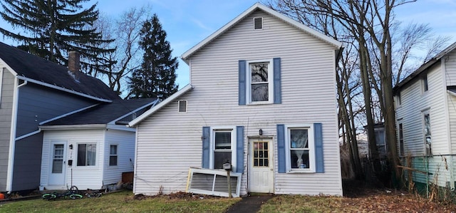 rear view of house with a yard