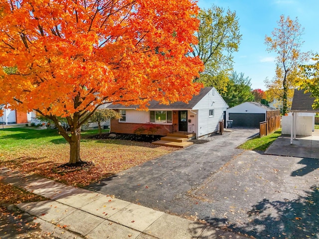 view of front of house with an outbuilding, a front lawn, and a garage