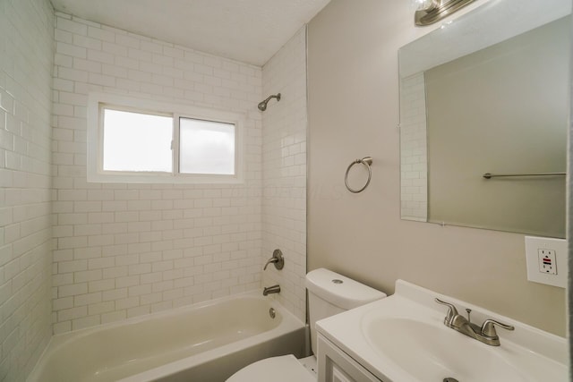 full bathroom featuring vanity, tiled shower / bath combo, and toilet