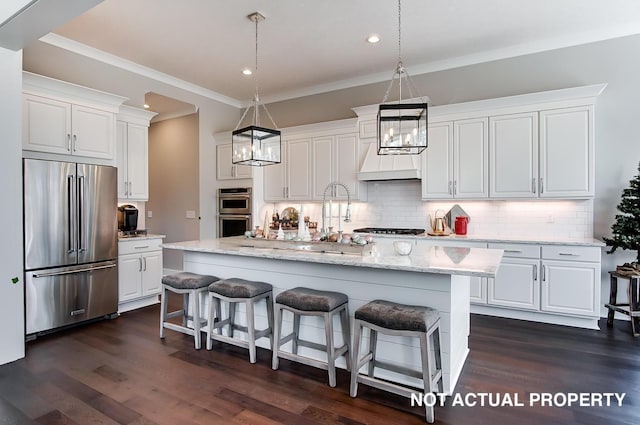 kitchen featuring white cabinets, stainless steel appliances, and a kitchen island with sink