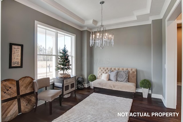 sitting room with a tray ceiling, dark hardwood / wood-style flooring, and a chandelier