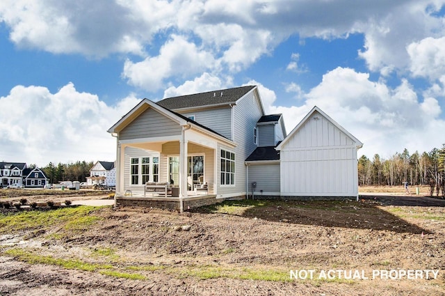 rear view of property with a porch