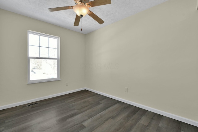 empty room with ceiling fan, dark hardwood / wood-style flooring, and a textured ceiling