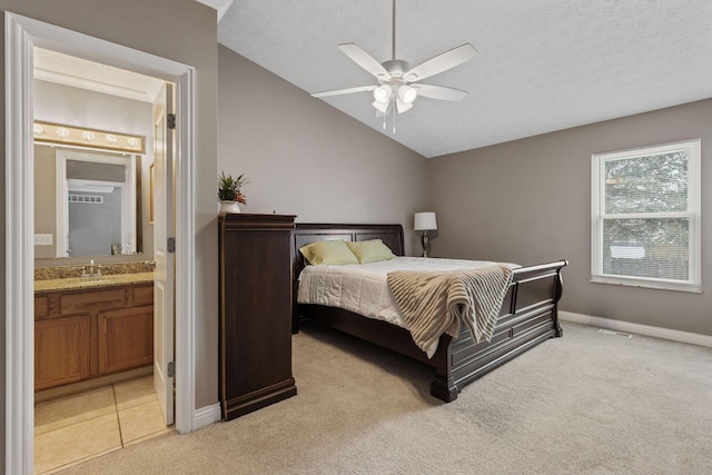 bedroom with ensuite bathroom, ceiling fan, light carpet, and lofted ceiling