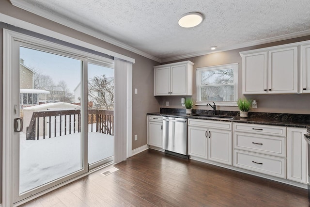 kitchen with a textured ceiling, dishwasher, white cabinetry, sink, and ornamental molding