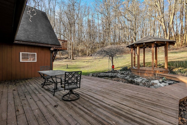 wooden deck featuring a yard