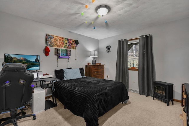 bedroom with light carpet and a textured ceiling