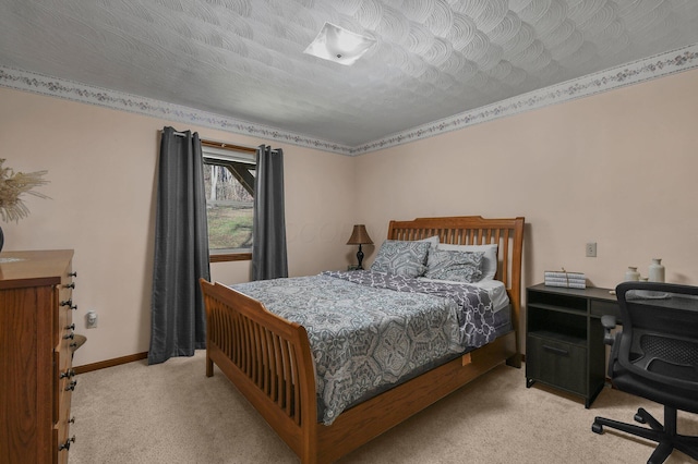 bedroom with a textured ceiling and light carpet