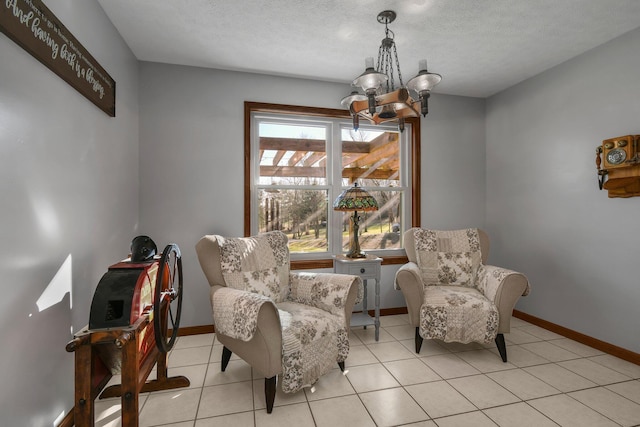 living area featuring light tile patterned floors, a textured ceiling, and an inviting chandelier