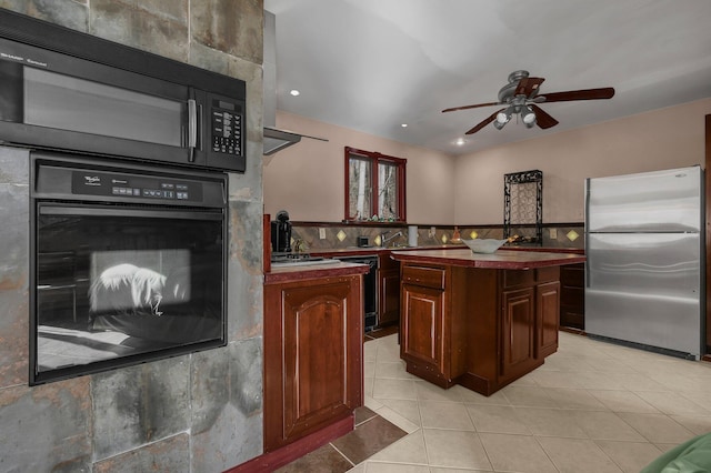 kitchen featuring black appliances, ceiling fan, and a kitchen island