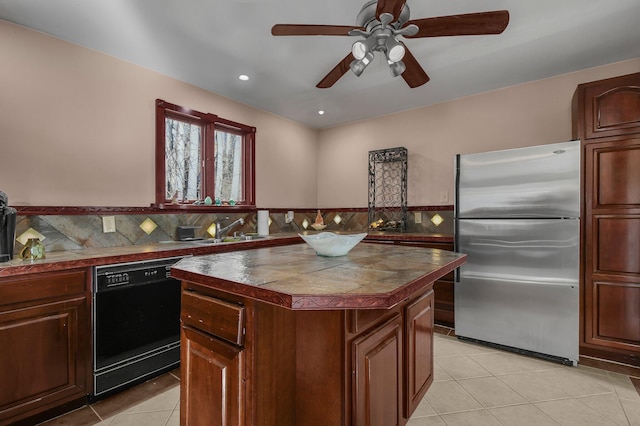 kitchen featuring sink, light tile patterned floors, dishwasher, a center island, and stainless steel refrigerator