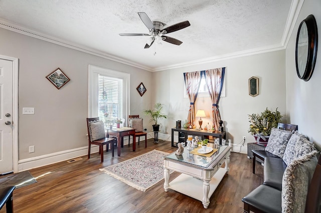 sitting room with a textured ceiling, dark hardwood / wood-style floors, ceiling fan, and ornamental molding