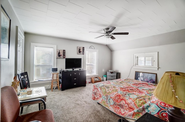 bedroom featuring multiple windows, carpet, ceiling fan, and lofted ceiling