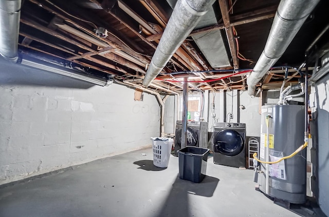 basement featuring gas water heater and separate washer and dryer