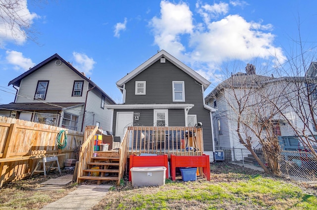 rear view of property featuring a deck